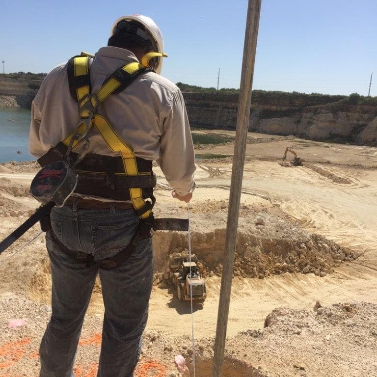 Worker harnessed on rock face